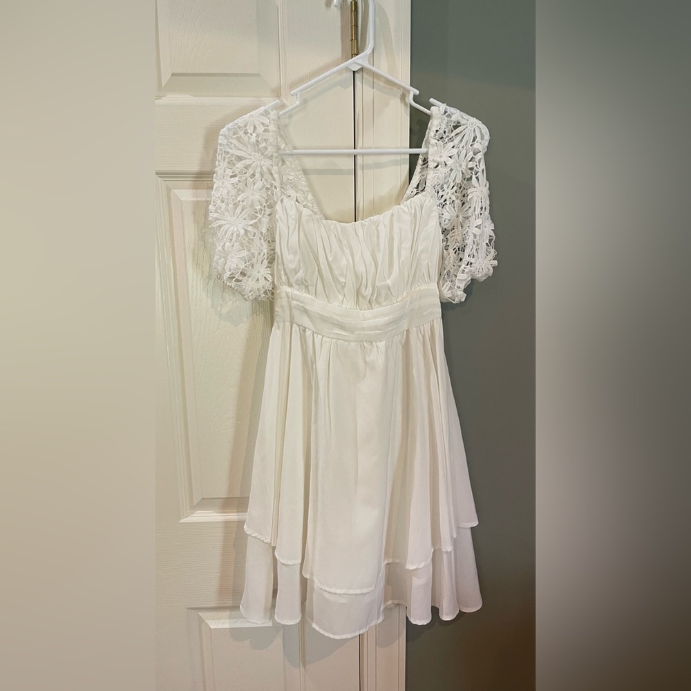 White dress with flowy skirt and bow tie